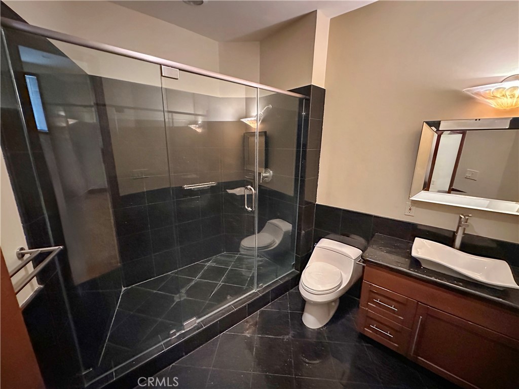 5077 Schumacher Road Calabasas, CA 91302 - Photo 43 of 58 a bathroom with a toilet and a sink