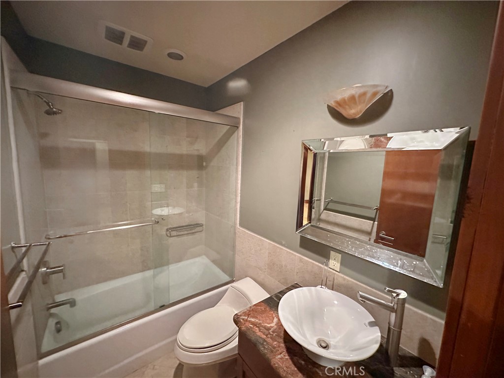 5077 Schumacher Road Calabasas, CA 91302 - Photo 47 of 58 a bathroom with a toilet a sink and bathtub