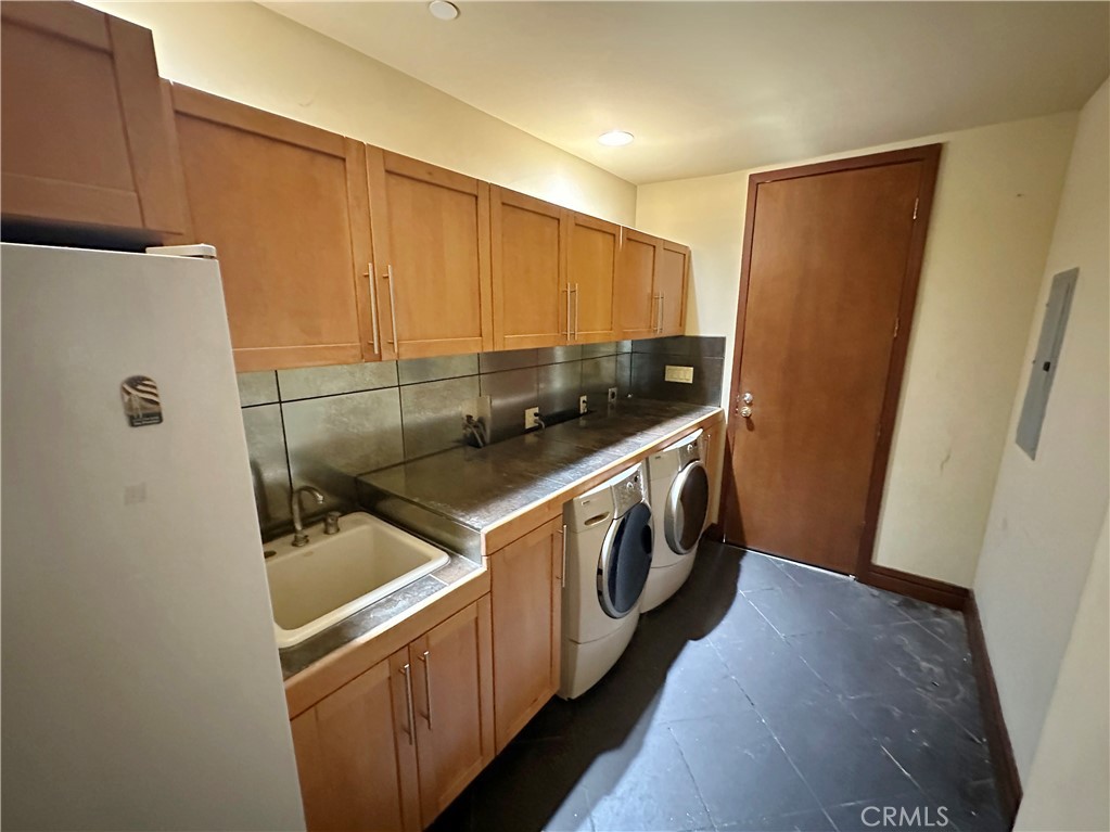 5077 Schumacher Road Calabasas, CA 91302 - Photo 49 of 58 a utility room with washer and dryer