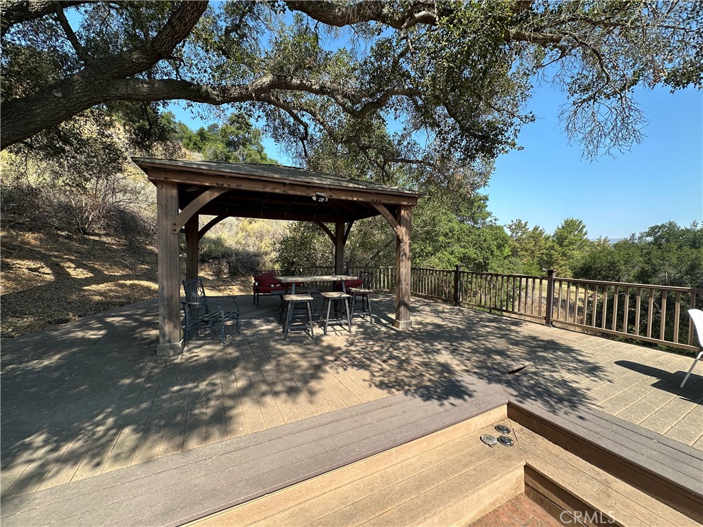 5077 Schumacher Road Calabasas, CA 91302 - Photo 50 of 58 a view of a wooden chairs and deck with wooden floor