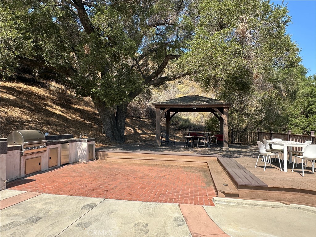 5077 Schumacher Road Calabasas, CA 91302 - Photo 52 of 58 a view of a swimming pool with an outdoor seating
