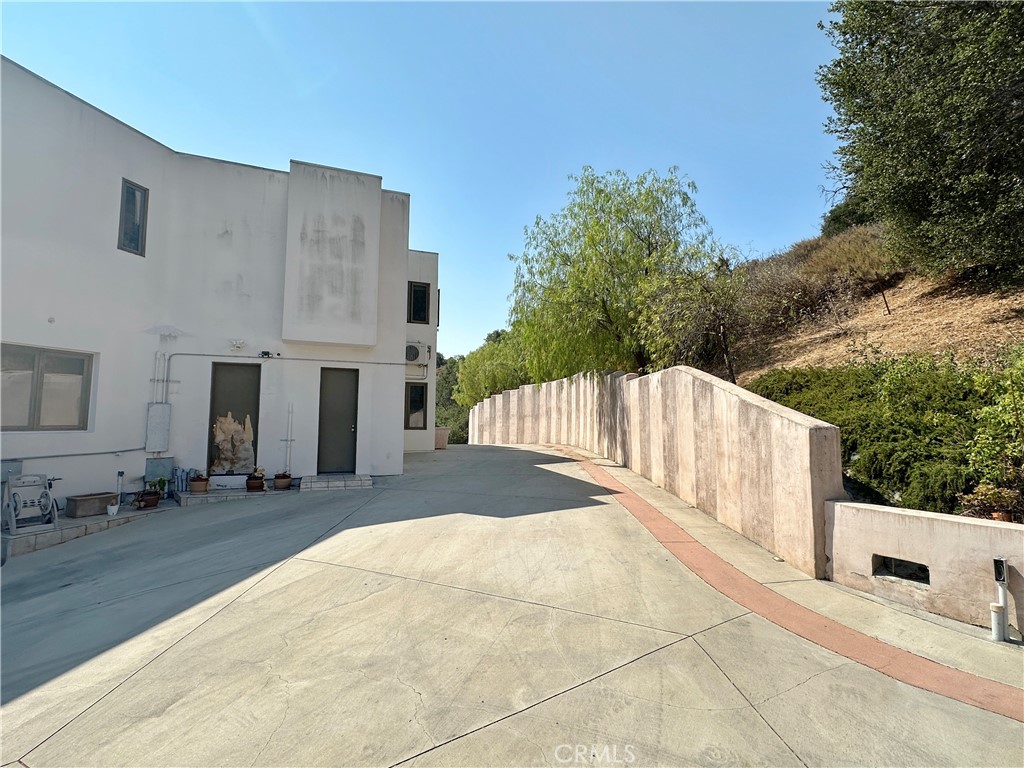5077 Schumacher Road Calabasas, CA 91302 - Photo 53 of 58 a view of a house with a yard