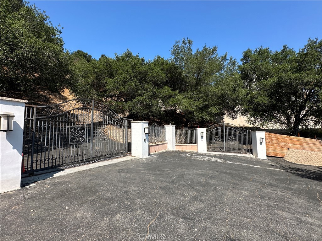 5077 Schumacher Road Calabasas, CA 91302 - Photo 58 of 58 a front view of a house with a garage