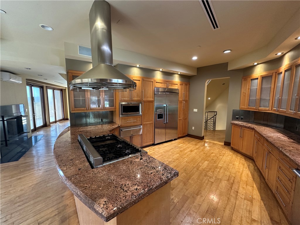 5077 Schumacher Road Calabasas, CA 91302 - Photo 10 of 58 a kitchen with stainless steel appliances granite countertop a sink stove and cabinets