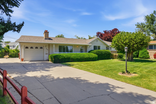 148 Tennyson Avenue Sandy, UT 84070 - Photo 2 of 55 Ranch-style residence featuring a prominent front lawn, mature landscaping, and a concrete driveway