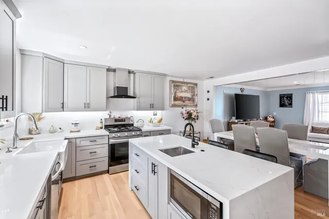 a large kitchen with a table and chairs in it