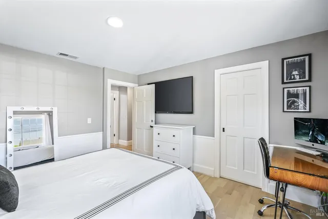 a bedroom with a bed and a mirror