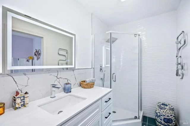 a bedroom with a bed and a ceiling fan