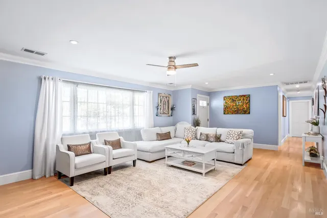 a living room with furniture and view of kitchen
