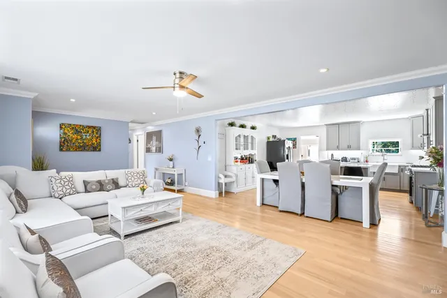 a kitchen with a sink a stove and chairs