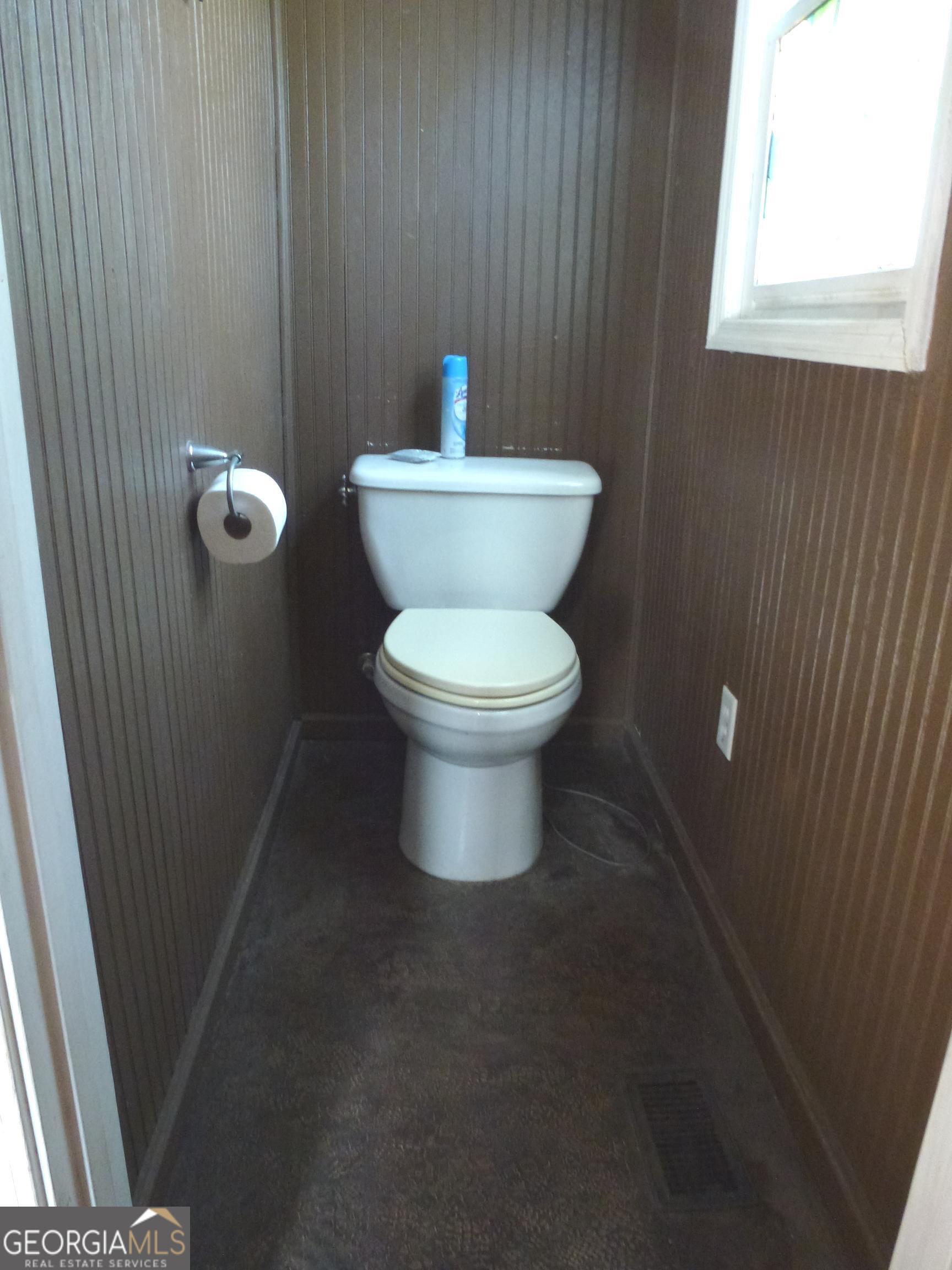 352 Riverside Drive Claxton, GA 30417 - Photo 19 of 25 a white toilet sitting next to a bathroom sink