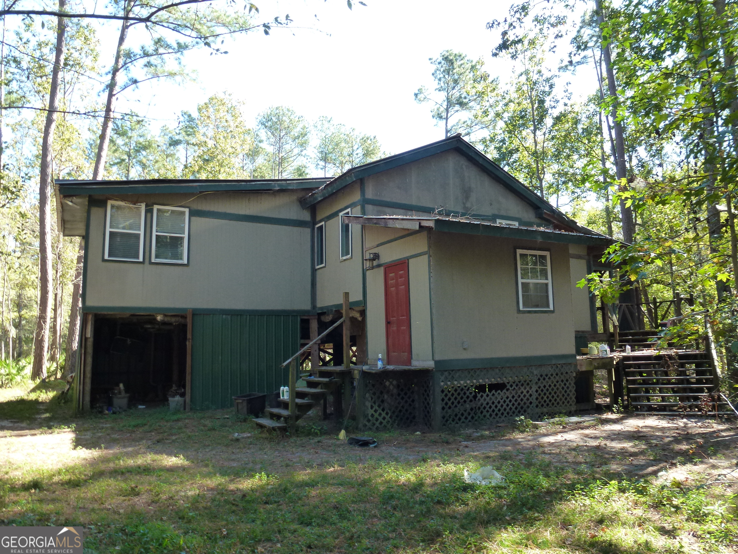 352 Riverside Drive Claxton, GA 30417 - Photo 2 of 25 a view of a house with a yard and a large tree