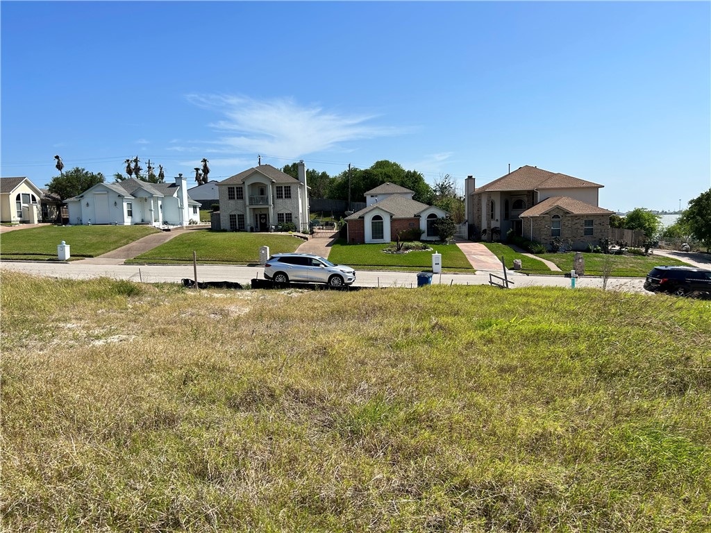 1009 Bluff Drive Portland, TX 78374 - Photo 2 of 4 a view of pool with lawn chairs and large trees