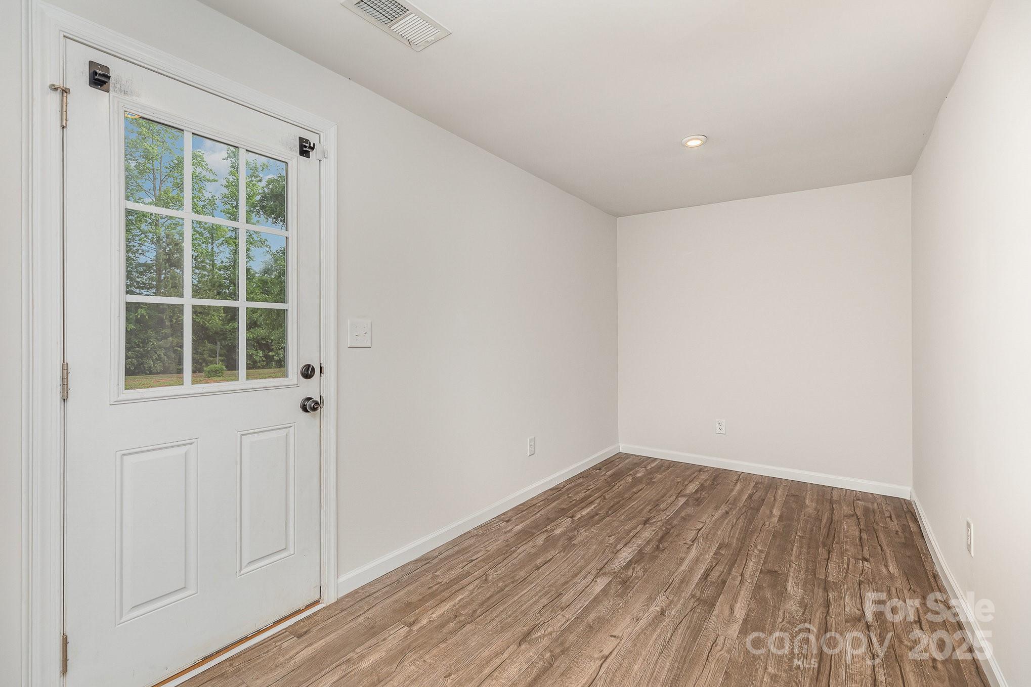 828 Renee Avenue Fort Mill, SC 29715 - Photo 19 of 23 an empty room with wooden floor and windows