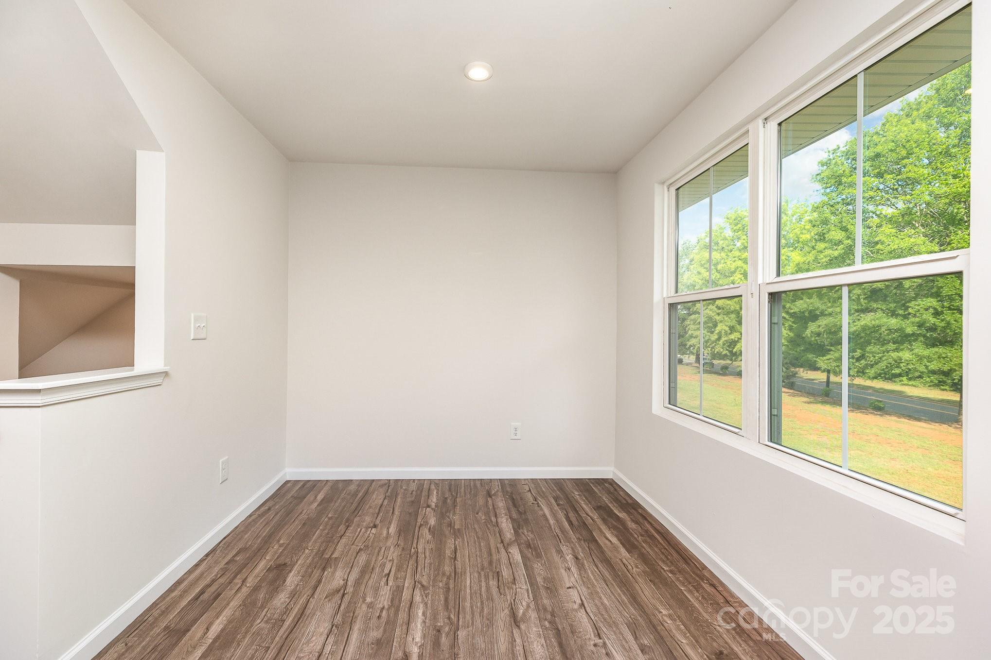 828 Renee Avenue Fort Mill, SC 29715 - Photo 20 of 23 a view of a room with wooden floor and windows