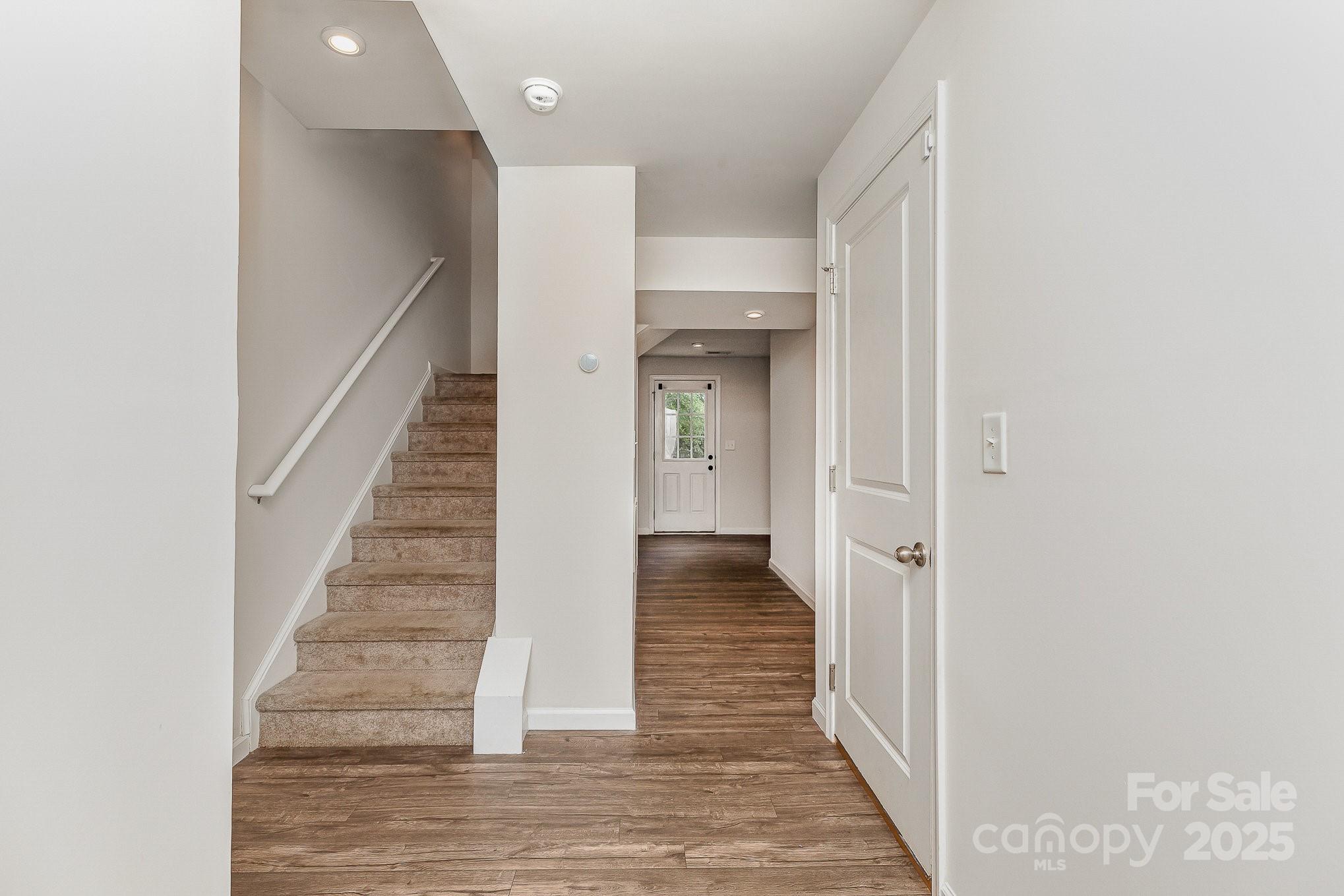 828 Renee Avenue Fort Mill, SC 29715 - Photo 3 of 23 a view of a hallway with the wooden floor and staircase