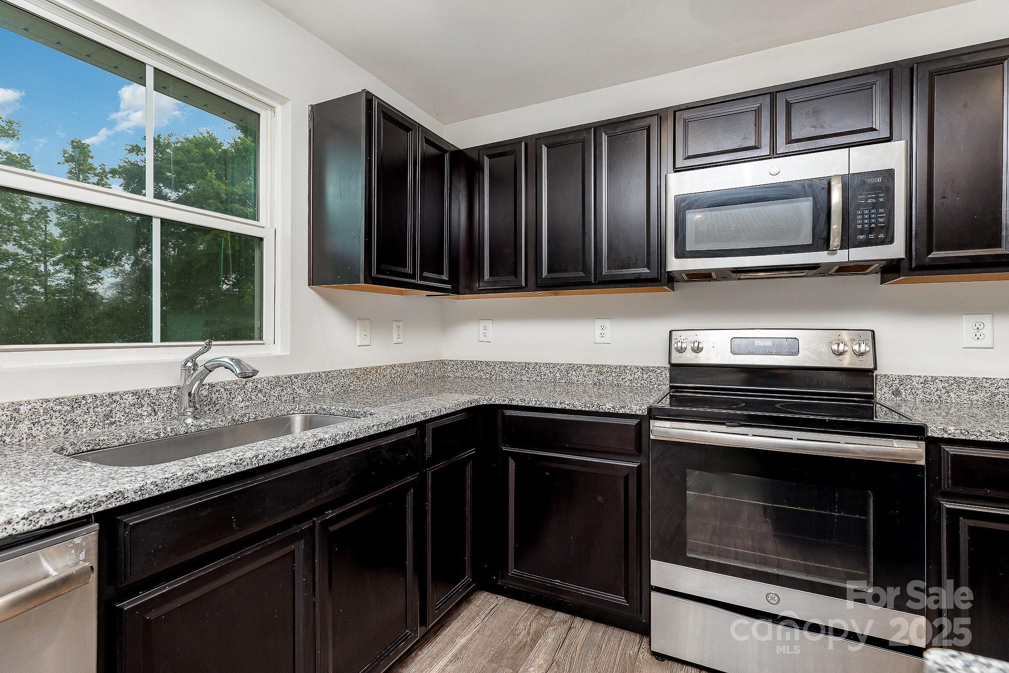828 Renee Avenue Fort Mill, SC 29715 - Photo 8 of 23 a kitchen with granite countertop cabinets stainless steel appliances and a sink