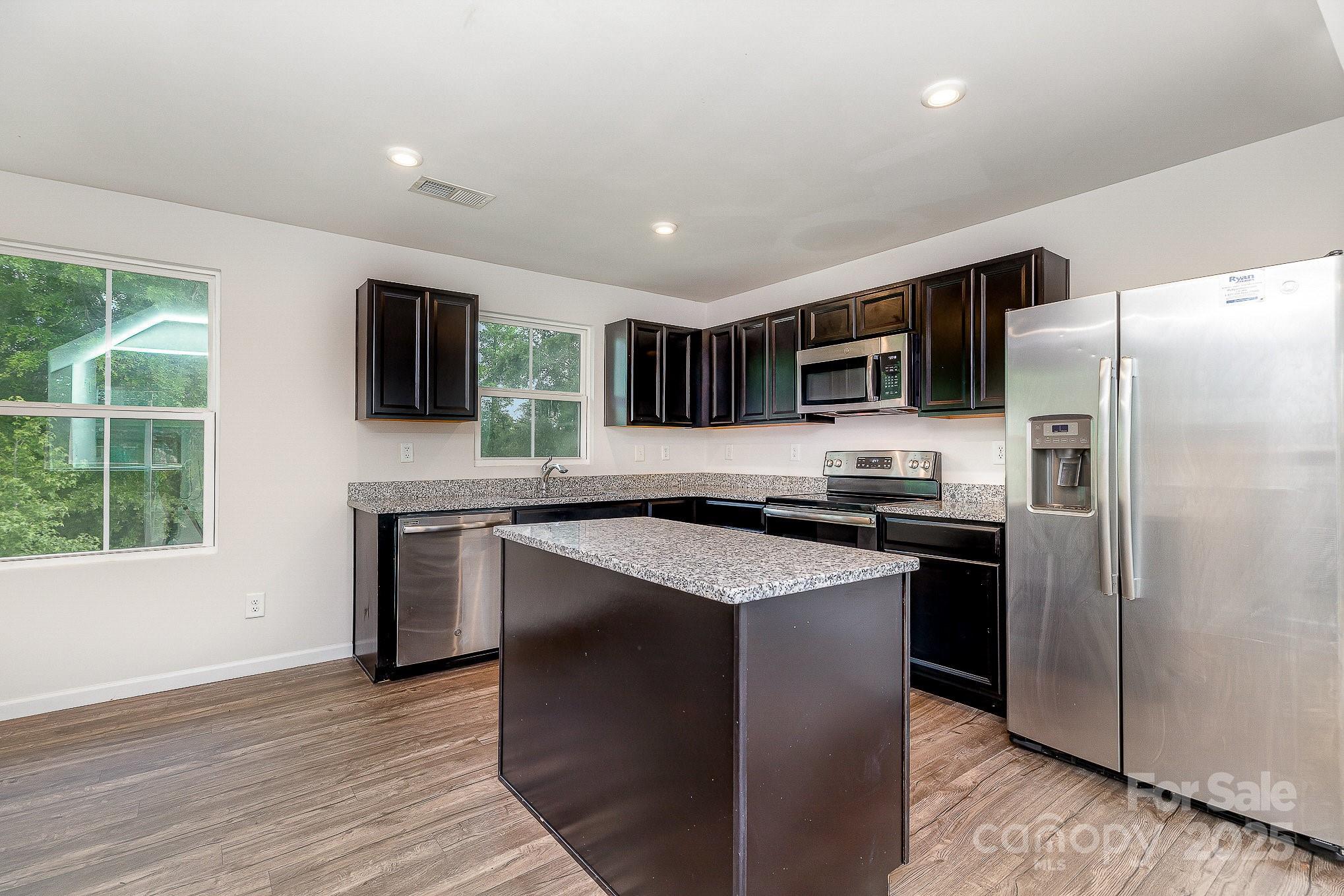 828 Renee Avenue Fort Mill, SC 29715 - Photo 10 of 23 a kitchen with stainless steel appliances granite countertop a refrigerator stove microwave and sink