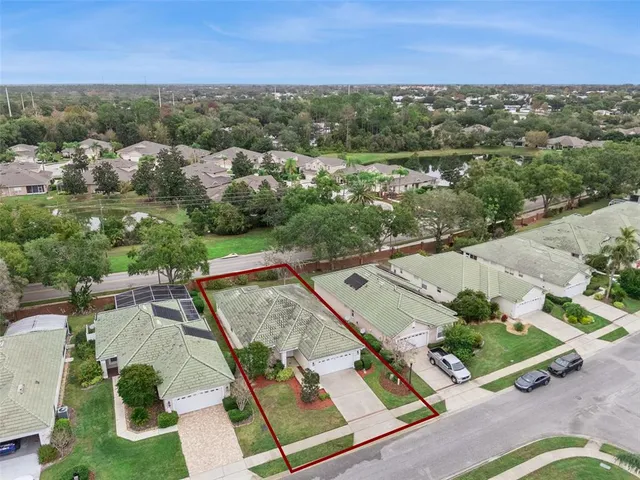 an aerial view of a house with a yard