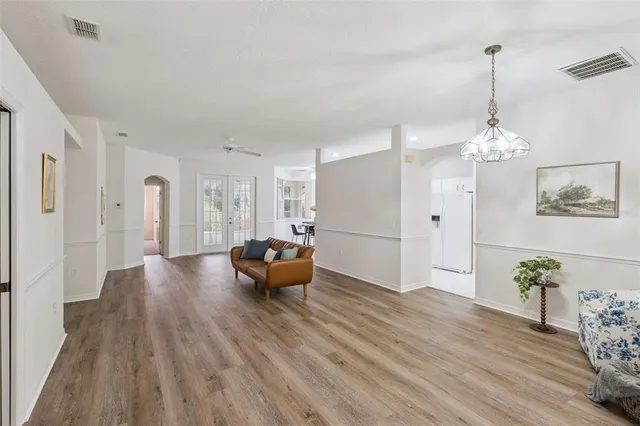 a living room with furniture and a chandelier