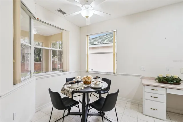 a view of a dining room with furniture and chandelier