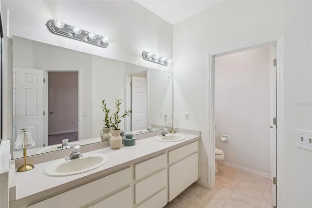 a bathroom with double sink and a mirror