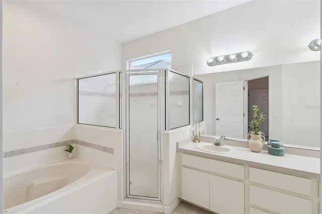 a bathroom with a bathtub shower sink and mirror