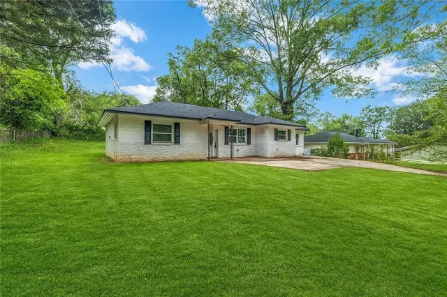 a front view of house with yard and green space