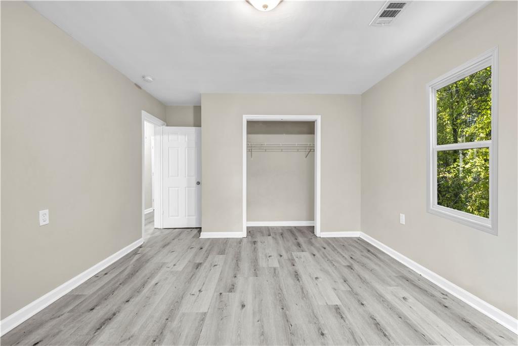 305 South 18th Street Griffin, GA 30224 - Photo 12 of 36 a view of an empty room with wooden floor and a window