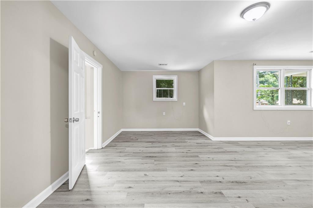 305 South 18th Street Griffin, GA 30224 - Photo 13 of 36 a view of an empty room with wooden floor and a window