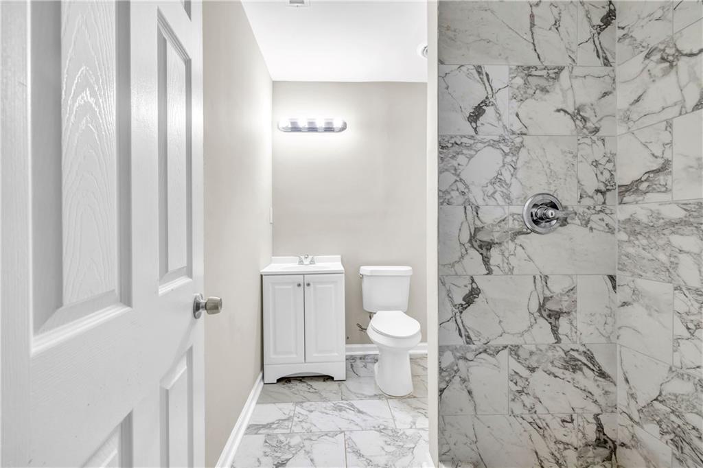 305 South 18th Street Griffin, GA 30224 - Photo 16 of 36 a bathroom with a toilet and a shower