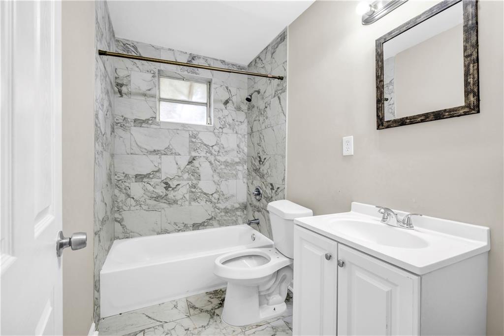 305 South 18th Street Griffin, GA 30224 - Photo 17 of 36 a bathroom with a sink a toilet and shower