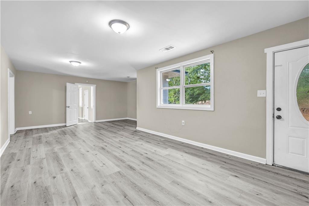 305 South 18th Street Griffin, GA 30224 - Photo 20 of 36 a view of an empty room with wooden floor and a window
