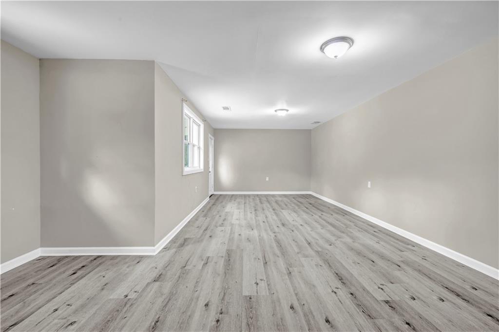 305 South 18th Street Griffin, GA 30224 - Photo 24 of 36 wooden floor in an empty room with a window