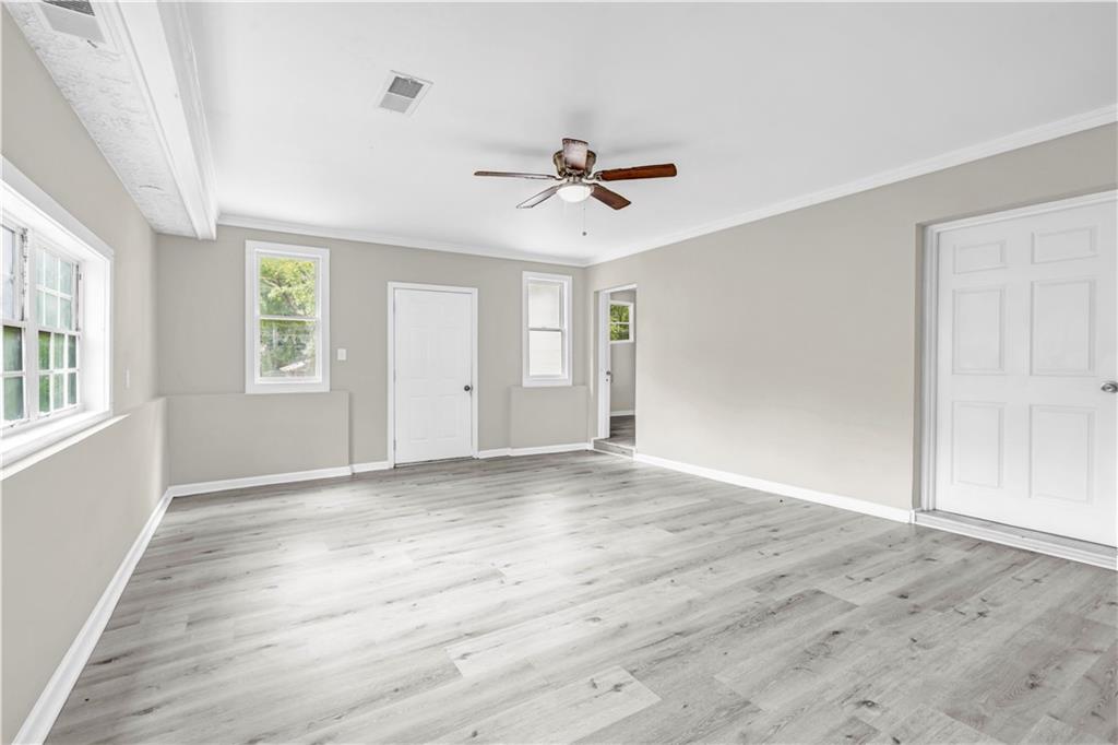 305 South 18th Street Griffin, GA 30224 - Photo 26 of 36 wooden floor in an empty room with a window