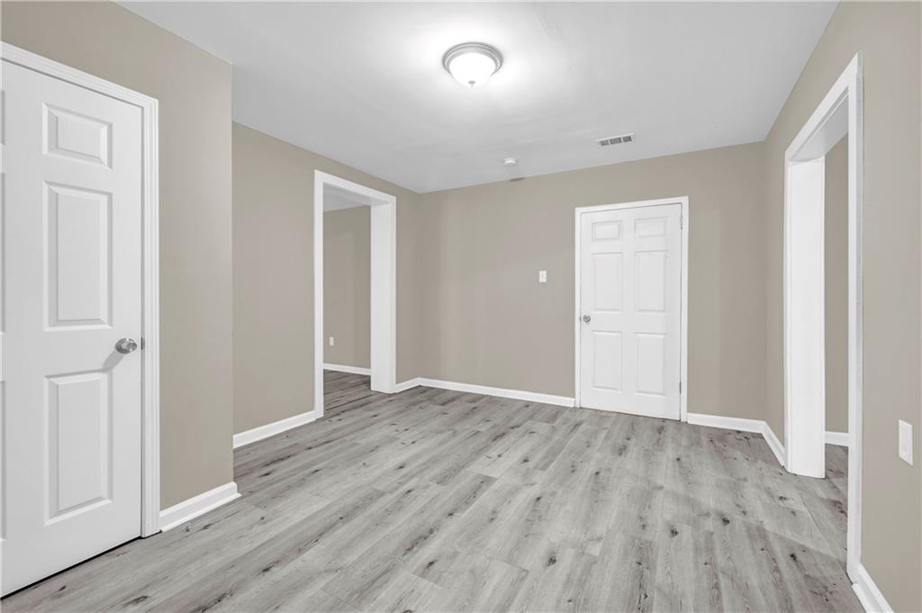 305 South 18th Street Griffin, GA 30224 - Photo 28 of 36 wooden floor in an empty room with a window