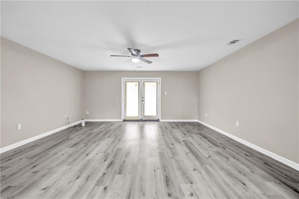305 South 18th Street Griffin, GA 30224 - Photo 30 of 36 an empty room with wooden floor and windows