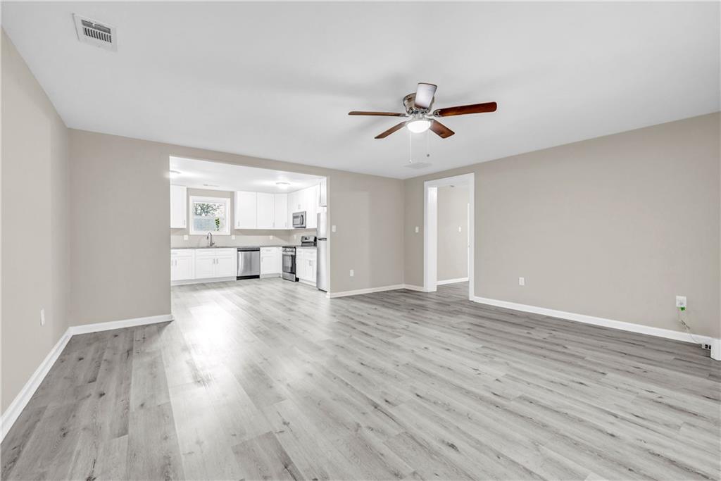 305 South 18th Street Griffin, GA 30224 - Photo 31 of 36 a view of a livingroom with hardwood floor and a ceiling fan