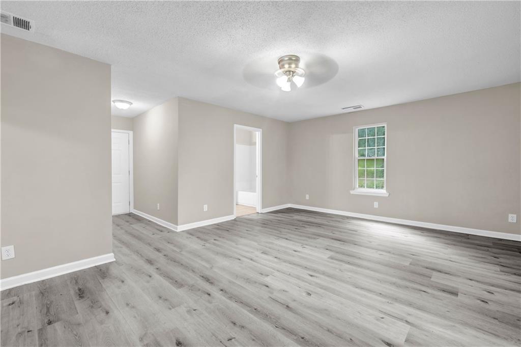 305 South 18th Street Griffin, GA 30224 - Photo 32 of 36 wooden floor in an empty room with a window