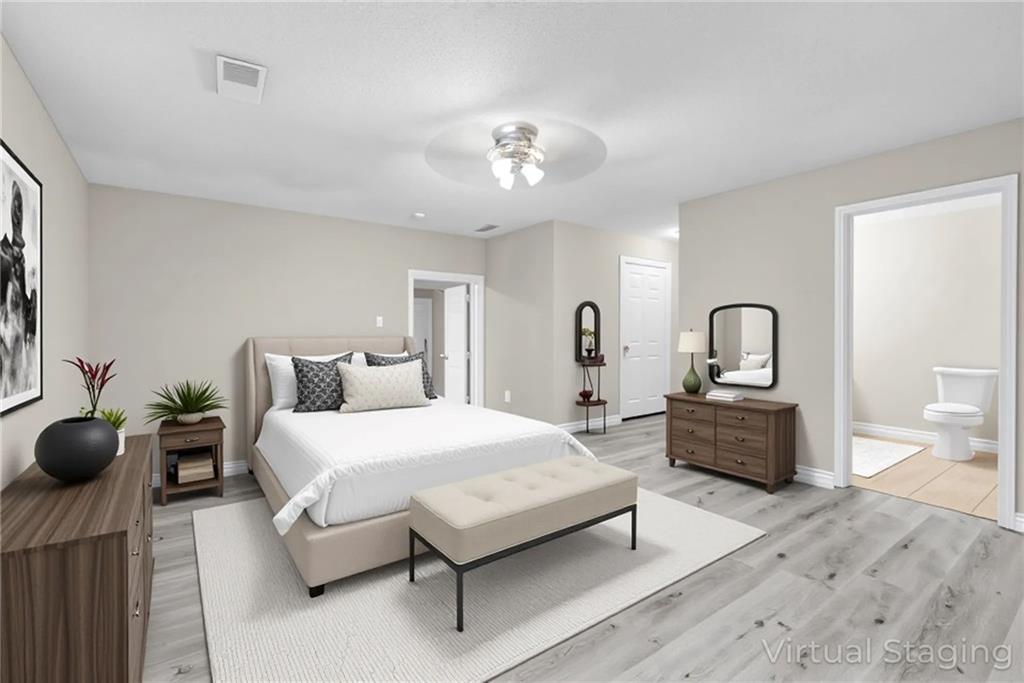 305 South 18th Street Griffin, GA 30224 - Photo 6 of 36 a bedroom with furniture and a chandelier