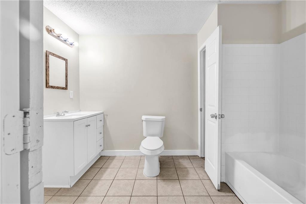 305 South 18th Street Griffin, GA 30224 - Photo 7 of 36 a bathroom with a toilet sink and a bathtub