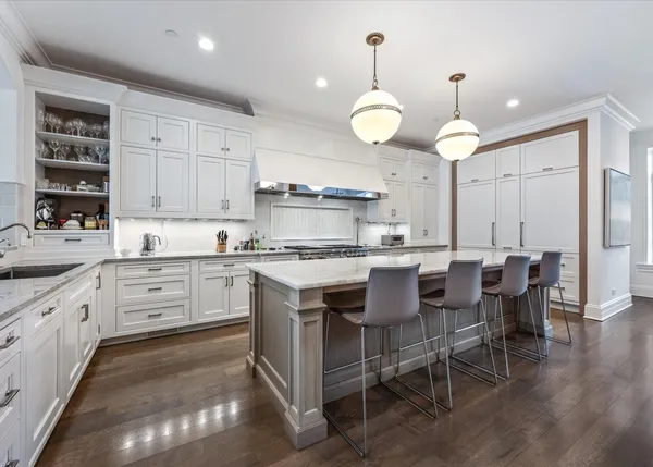a kitchen with cabinets appliances and a dining table