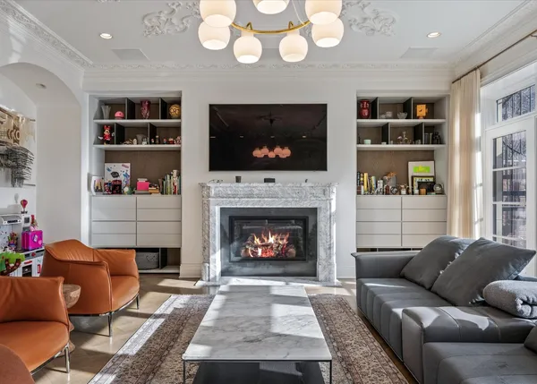 a living room with furniture a flat screen tv and a fireplace