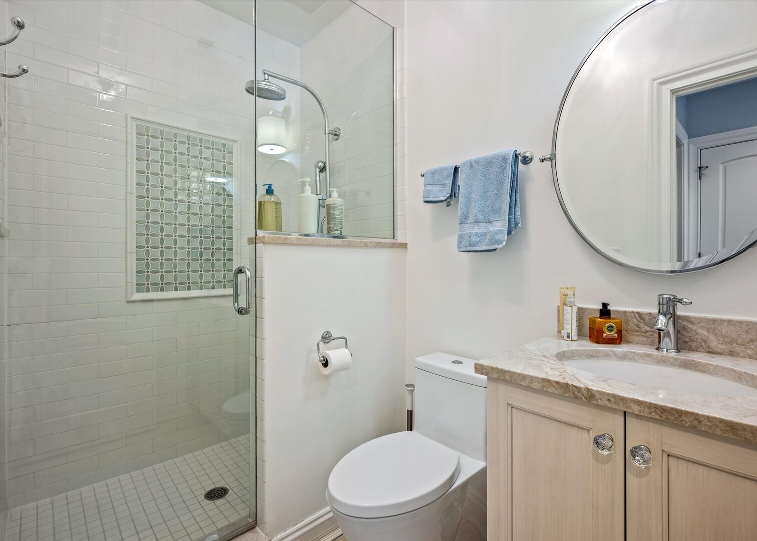 441 West Deming Place Chicago, IL 60614 - Photo 37 of 54 a bathroom with a granite countertop sink a mirror a toilet and shower
