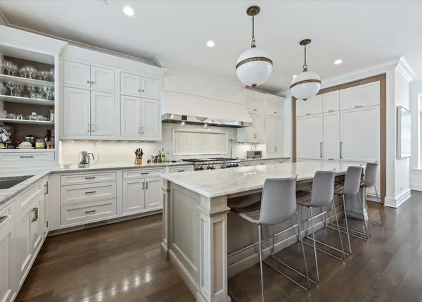 a kitchen with cabinets appliances and a dining table