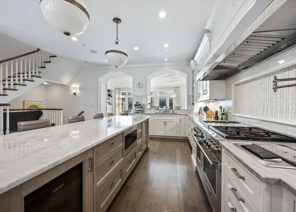 a large kitchen with stainless steel appliances granite countertop a lot of counter space