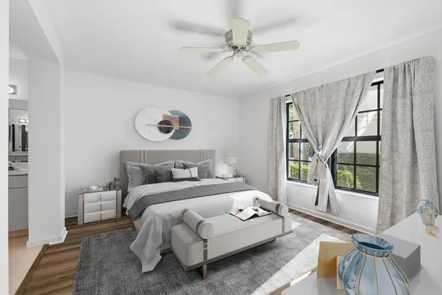 a bedroom with a bed and a large window