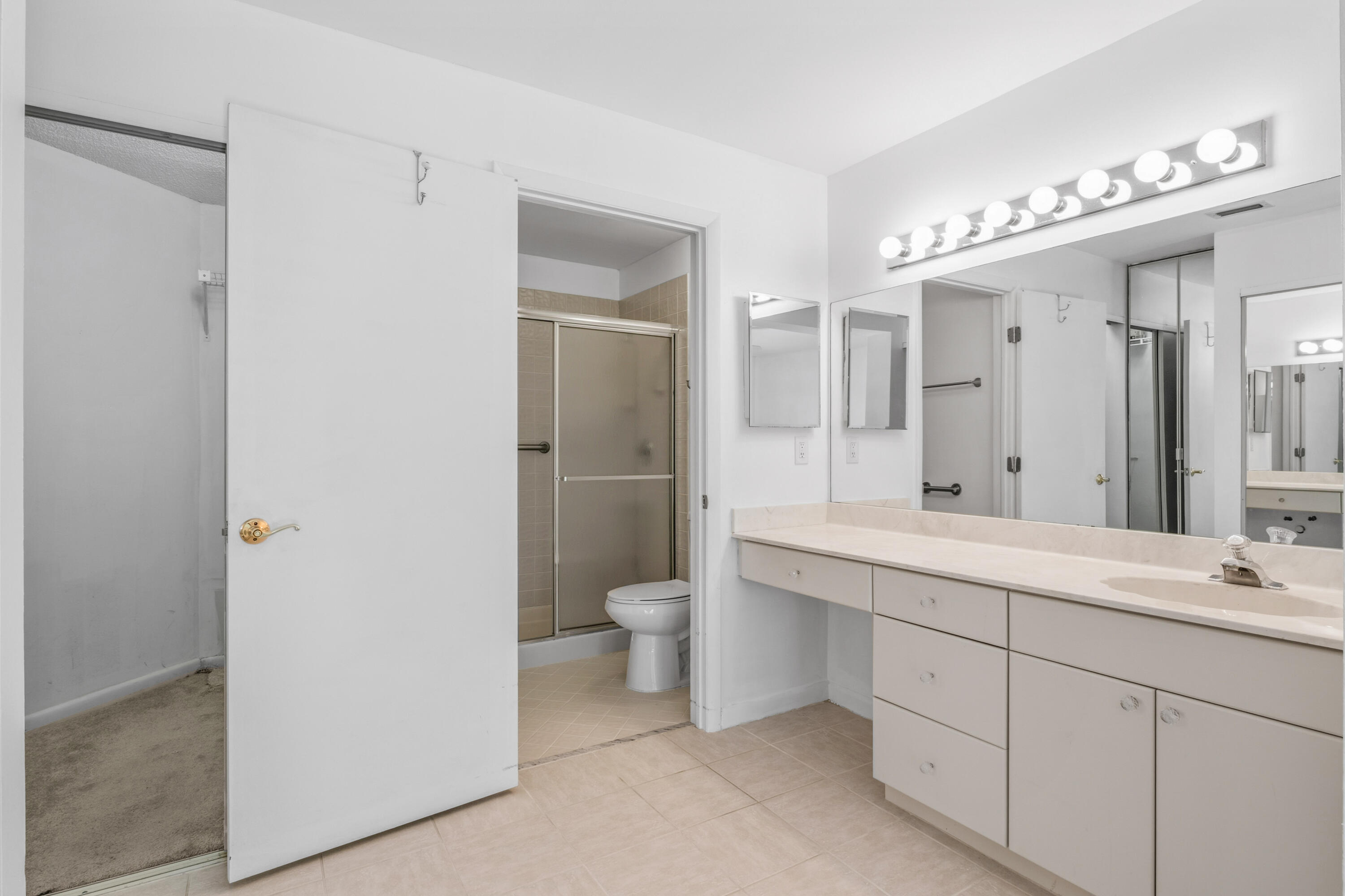 3233 Perimeter Drive, Unit 2511 Greenacres, FL 33467 - Photo 13 of 39 a spacious bathroom with a double vanity sink mirror and toilet