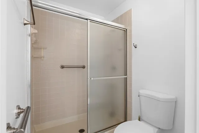 a bathroom with a shower and a toilet