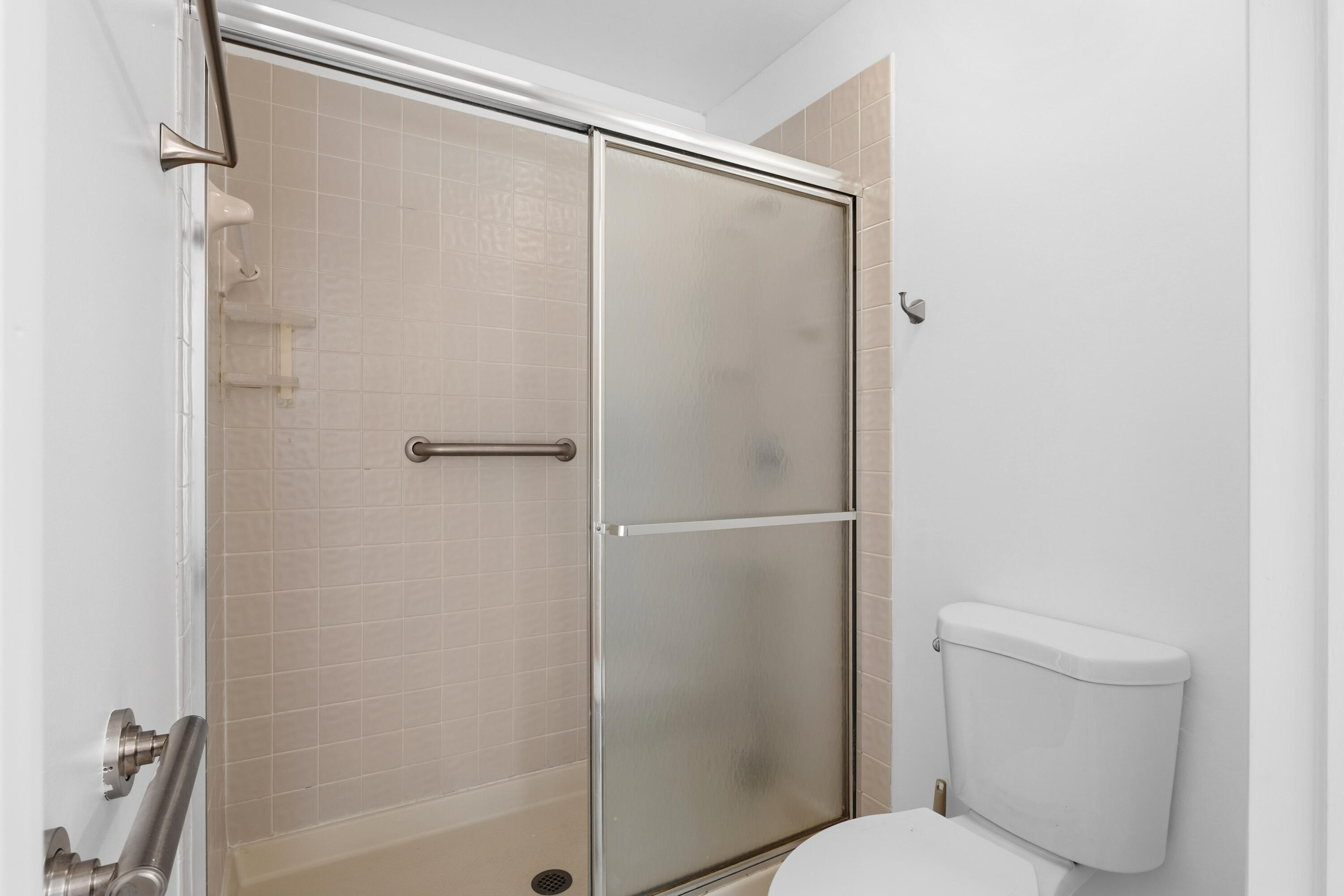3233 Perimeter Drive, Unit 2511 Greenacres, FL 33467 - Photo 14 of 39 a bathroom with a shower and a toilet
